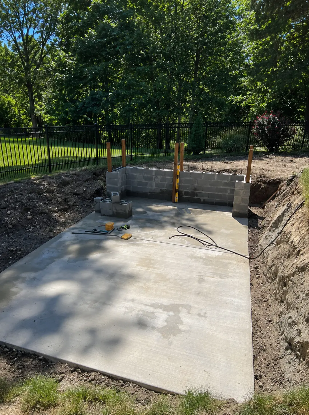 Prepared concrete foundation pad for a container pool installation